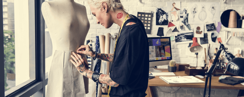 Business owner organizes clothes in retail shop