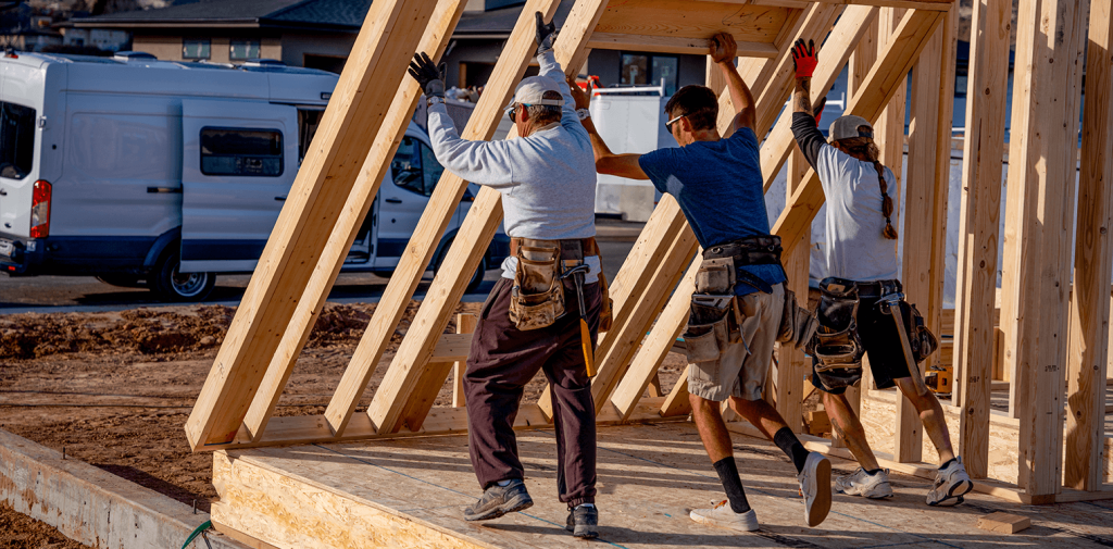 Three workers who have workers' compensation insurance in New York are building a house