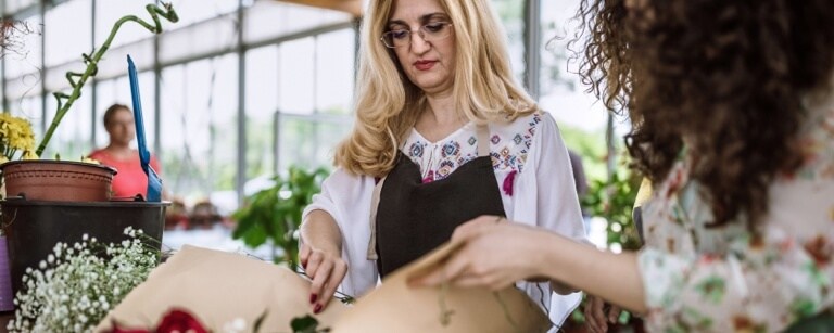 A florist shows a client options