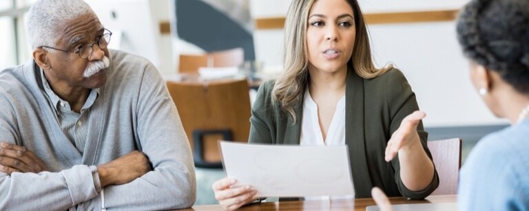 A female lawyer meeting with two clients