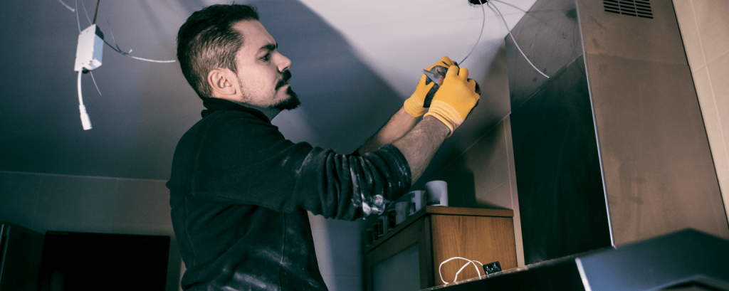 Electrician installs recessed lighting