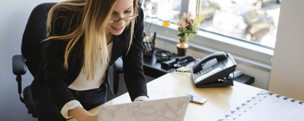Business owner works at wooden desk