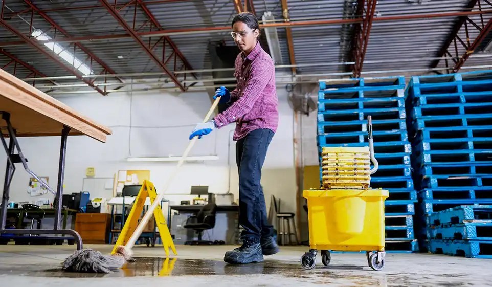 Small business owner mopping their space