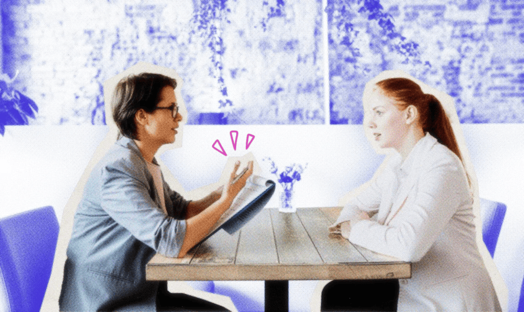 Small business owner interviewing a potential employee at a table