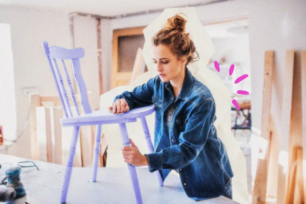 Craft business owner working on finishing a chair.